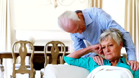 Upset-senior-couple-arguing-with-each-other-in-living-room