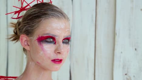 Portrait-of-mysterious-girl-with-creative-make-up-and-elegant-hairstyle