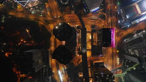 night-time-illuminated-hong-kong-city-downtown-traffic-street-aerial-topdown-panorama-4k