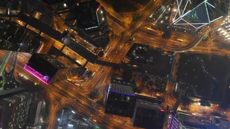 night-time-illuminated-hong-kong-city-downtown-traffic-street-aerial-topdown-panorama-4k