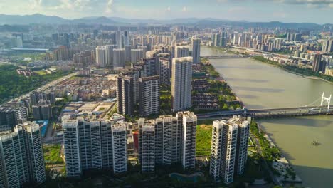 china-sunny-day-zhuhai-city-famous-living-block-riverside-aerial-panorama-4k-time-lapse