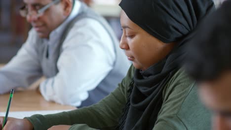 Arab-Woman-Studying-with-Group-of-Migrants