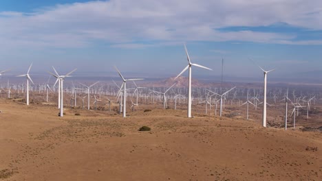 Aerial-view-of-giant-wind-turbine-field-shot-from-above-looking-down-creating-clean-renewable-energy