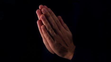 Male-praying-with-hands-clasped