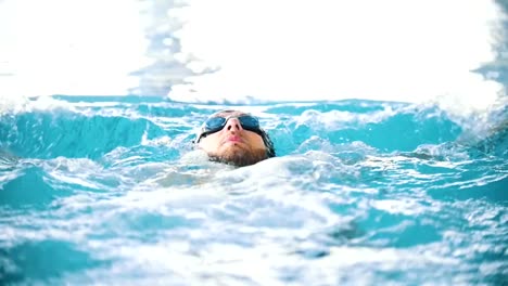 Disabled-man-swimming-on-the-back-in-a-swimming-pool.-The-butterfly-stroke.-Slow-motion