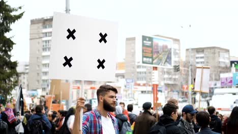 European-people-at-demonstration.-Man-with-a-banner-screaming-into-a-mouthpiece.