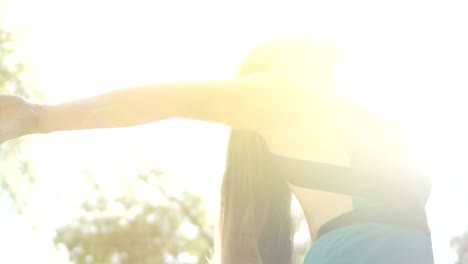 Woman-in-sun-rays-feels-freedom,-young-free-female-enjoys-summer,-looking-up-sky