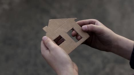 homeless-boy-holding-a-cardboard-house