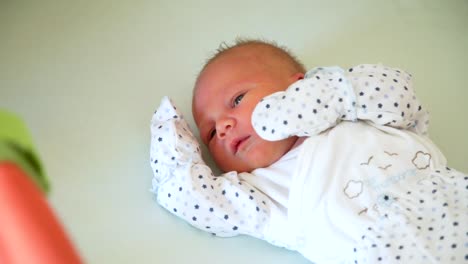 Father-Petting-Newborn-Baby-in-Crib