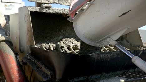 Pouring-concrete-cement-from-a-truck-into-a-pump.