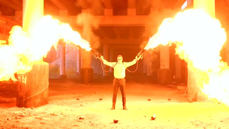 A-man-with-makeup-skeleton-Halloween-with-a-torches-with-strong-flame.-Fire-show