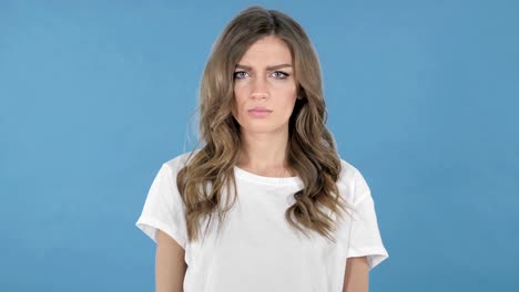 Fighting-Young-Girl-in-Anger-Isolated-on-Blue-Background