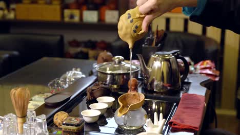 Master-pours-tea-leaves-with-water.-Tea-ceremony