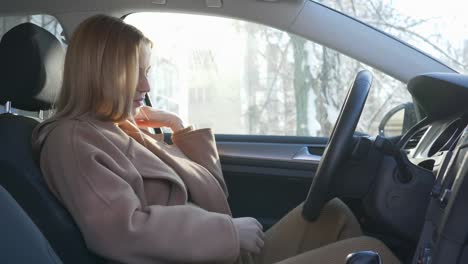 expectant-girl-closes-the-car-door-and-stroking-tummy-sitting-in-the-automobile-in-backlight