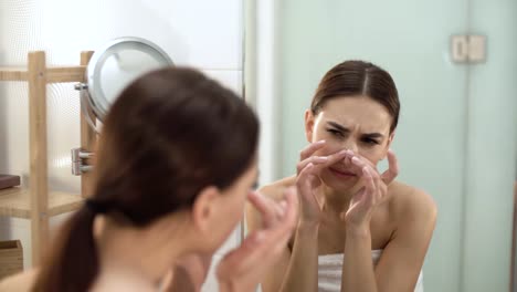 Problem-Skin.-Woman-Crushing-Spot-On-Face-And-Looking-In-Mirror