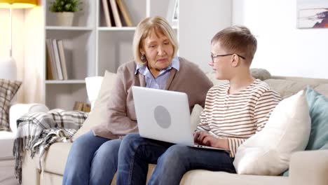 Retired-Woman-Watching-Her-Grandson-Using-PC