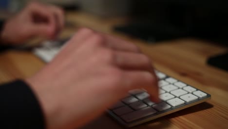 businessman-with-smartphone-and-laptop-sending-sms,-texting-in-the-office