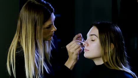 Make-up-artist-is-making-blonde-woman-up-as-dead-bride-for-Halloween-party.-4K