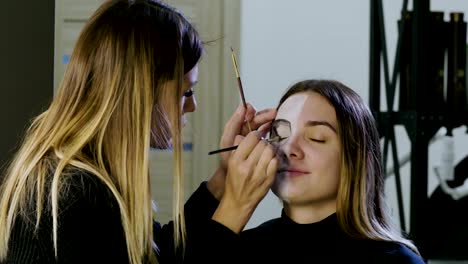 Make-up-artist-is-making-blonde-woman-up-as-dead-bride-for-Halloween-party.-4K