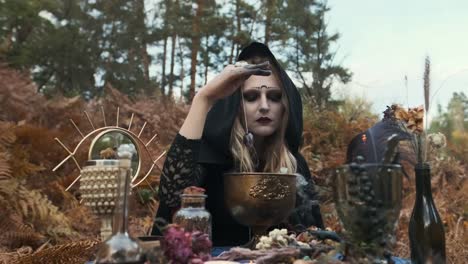 Halloween.-Young-Witch-Spells-At-The-Table.