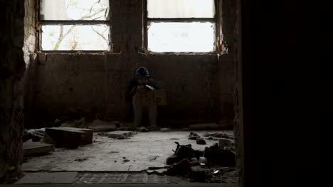 Frozen-hungry-homeless-with-plate-help-sits-in-abandoned-building