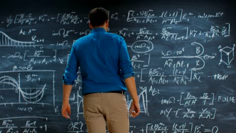 Brilliant-Young-Mathematician-Approaches-Blackboard-and-Finishes-Solving-Long-and-Complex-Equation.