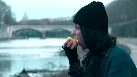 lonely-homeless-young-woman-eating-an-apple