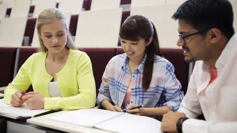 group-of-students-with-notebooks-in-lecture-hall