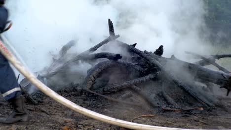 Ein-Feuer-mit-Wasser-durch-einen-Feuerwehrschlauch-löschen