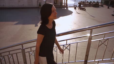 woman-climbing-stairs-against-amazing-city-landscape