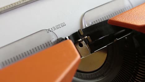 Close-up-footage-of-a-person-writing-DIABETES-on-an-old-typewriter