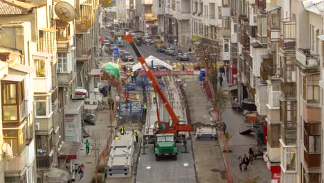 Unloading-concrete-plates-from-truck-by-crane-at-road-construction-site-timelapse