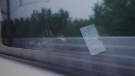 Cell-Phone-Reflection-in-Train-Window-Traveling-Commuting