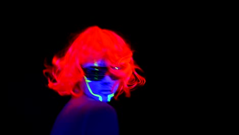 Woman-with-UV-cyborg-face-paint,-wig,-glowing-clothing-portrait-dancing-hard,-side-shot.-Asian-woman.-.