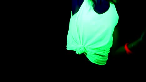 Woman-with-UV-face-paint,-glowing-clothing,-glowing-bracelet-dancing-in-front-of-camera,-Body-shot.-Caucasian-woman.-.