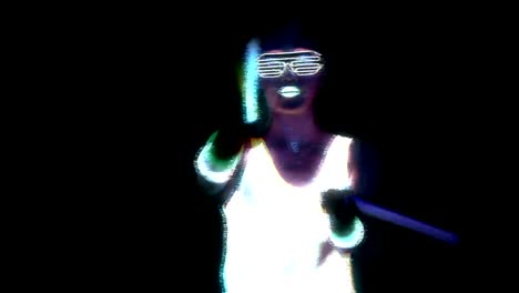 Woman-with-UV-face-paint,-glowing-clothing,-glowing-glasses,-bracelet-dancing-in-front-of-camera-holding-chemical-light,-half-body-shot.-Asian-woman.-Glitch-effect.-Women.