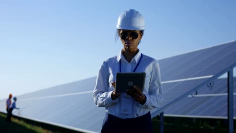 Female-electrical-worker-on-her-tablet-outside