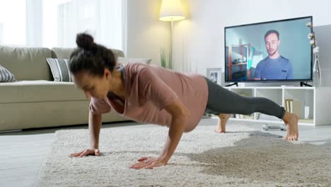 Woman-Doing-Workout-at-Home-with-Online-Fitness-Trainer