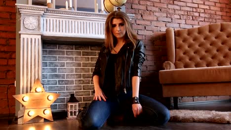 The-girl-in-black-leather-jackets-posing-sitting-on-the-floor