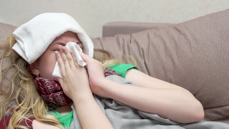 Teenage-girl-blows-her-nose-in-a-paper-handkerchief.-She-has-a-cold
