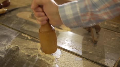 Male-hand-holding-wooden-mallet