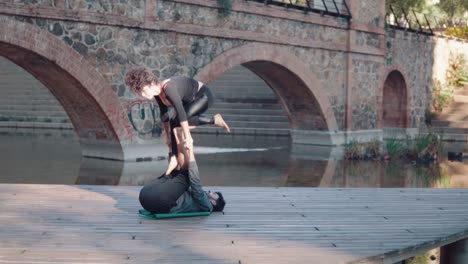 Beautiful-couple-practicing-acro-yoga-in-the-morning