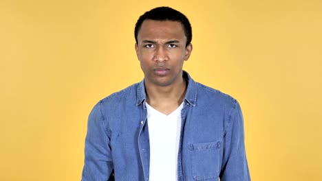 Young-African-Man-Showing-Middle-Finger-Isolated-on-Yellow-Background