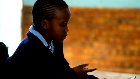 Schoolkid-using-digital-tablet-in-classroom-4k