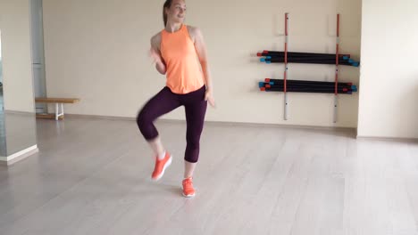 Young-pretty-girl-doing-dance-exercises-in-gym-or-studio.-fitness,-sport,-dance-and-lifestyle-concept