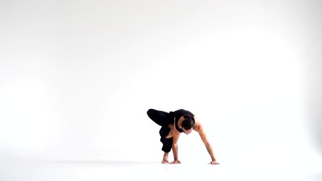 Man-practicing-intense-yoga-asana