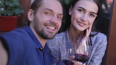 Happy-Couple-With-Wine-Taking-Photos-Camera-View