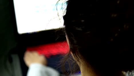 Hacker-Girl-Working-At-Computer-with-Lit-Keyboard-at-Dark