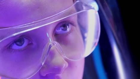 Portrait-of-a-young-girl-researcher-with-safety-glasses.