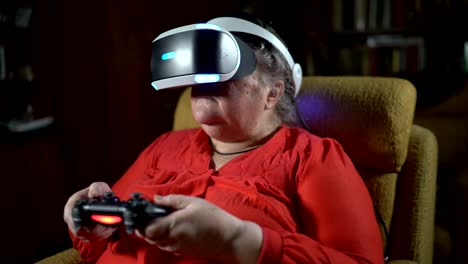 Elderly-woman-in-front-of-TV-screen-uses-VR-headset-and-wireless-gaming-controller